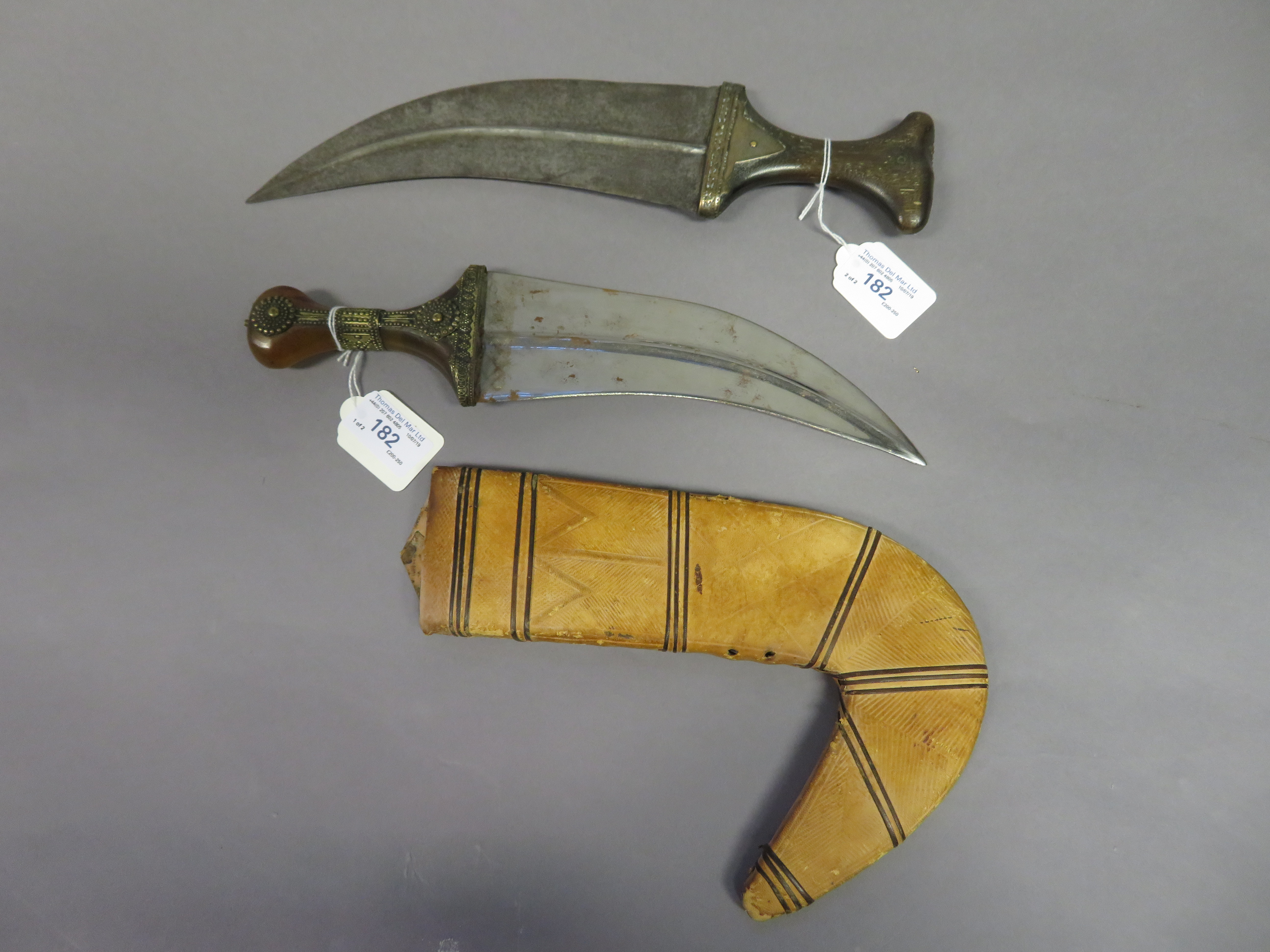 TWO ARAB DAGGERS (JAMBIYA), LATE 19TH/EARLY 20TH CENTURY each with broad curved blade formed with