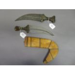 TWO ARAB DAGGERS (JAMBIYA), LATE 19TH/EARLY 20TH CENTURY each with broad curved blade formed with