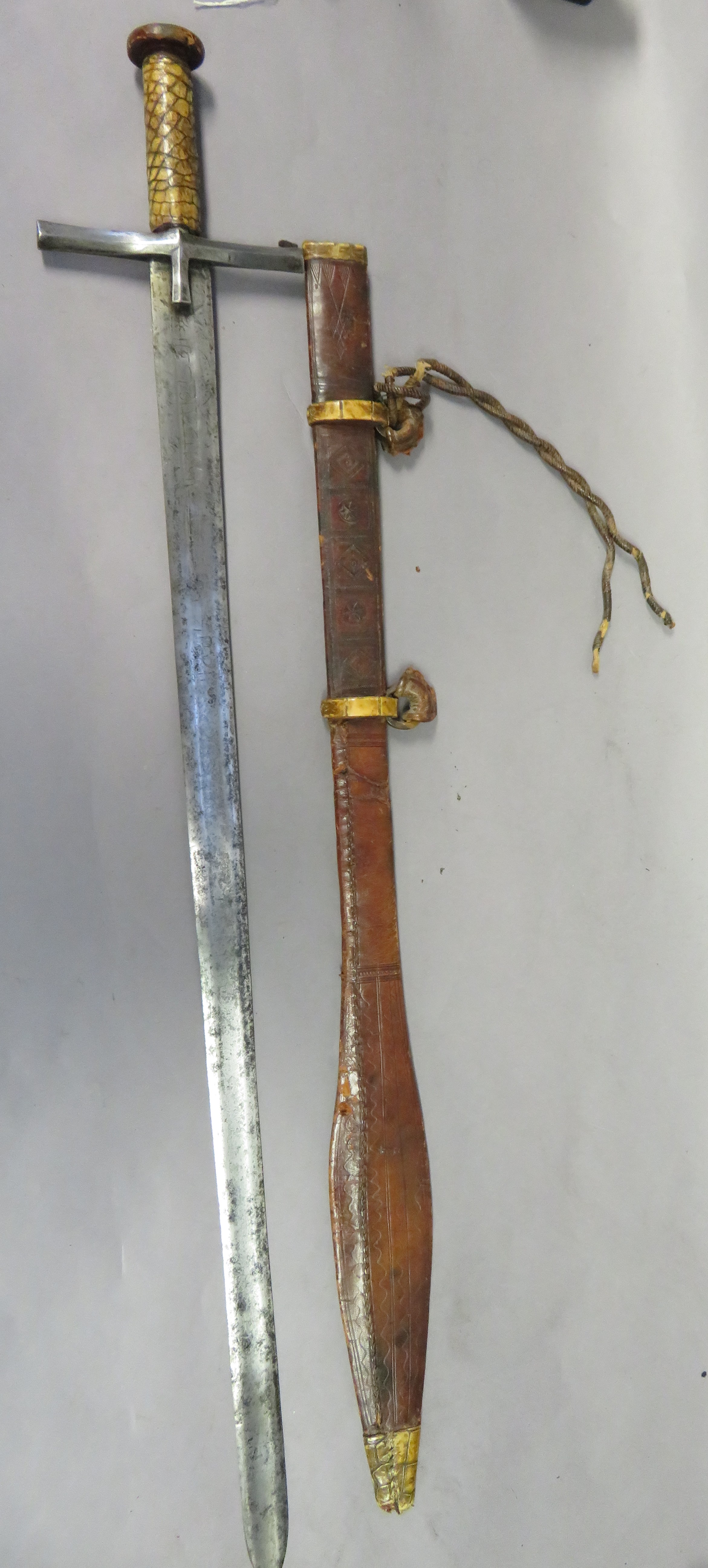 A SUDANESE SWORD (KASKARA), LATE 19TH CENTURY with broad double-edged blade cut with an