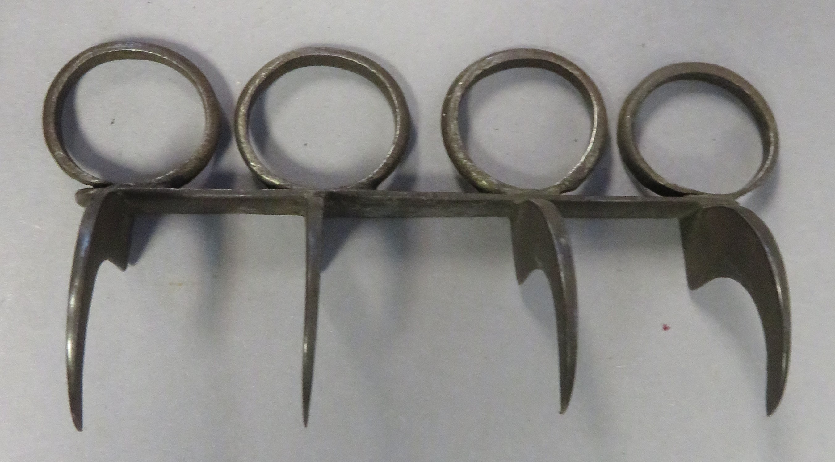 AN INDIAN IRON 'TIGER-CLAW' (BAGH NAKH), 19TH CENTURY formed of four characteristic hook-shaped