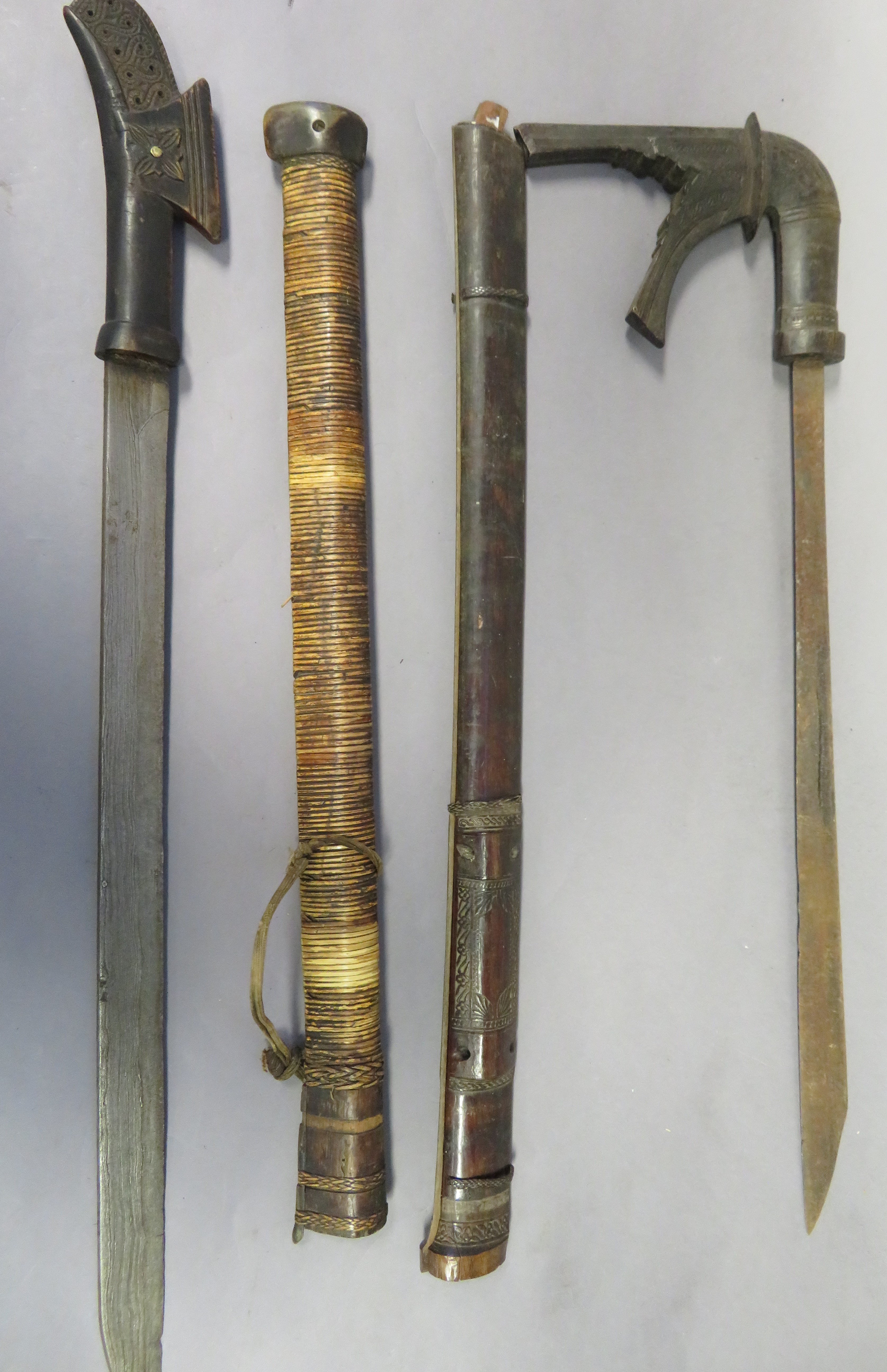 TWO MORO SWORDS (KLEWANG), LATE 19TH CENTURY the first with single-edged blade with a triangular