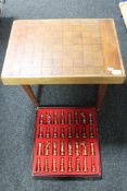 A chess table together with boxed set of metal chess pieces
