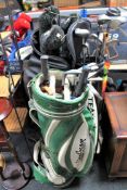 Three golf bags containing assorted irons and drivers