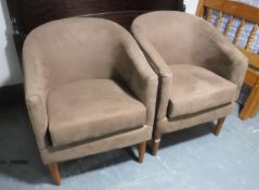 A pair of tub chairs upholstered in a brown fabric