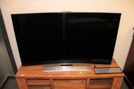 A Samsung 55 inch curved 3D TV, model UE 55 HU8500T, with switch box and remote.