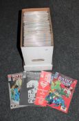 A box containing late 20th century DC comics including Justice League,