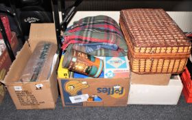 A wicker picnic set together with a box containing cool box, walker's kit, gas stove, travel rug,