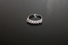 An 18ct white gold diamond seven stone ring, size N/O. approximately 0.75ct.