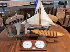 Two wooden ship models together with a wooden boat CD rack and an Abbey ship's style wall clock and
