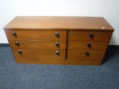 A mid 20th century teak six drawer chest CONDITION REPORT: 63cm high by 138cm wide