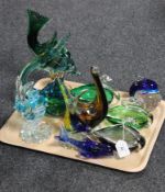 A tray containing six coloured glass fish ornaments together with four coloured glass bird bowls