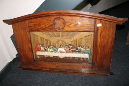 An Edwardian oak framed cast iron hand-painted panel depicting The Last Supper