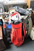 Three golf bags containing a large quantity of assorted putters