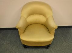 A Victorian lady's chair upholstered in golden fabric, width 76 cm.