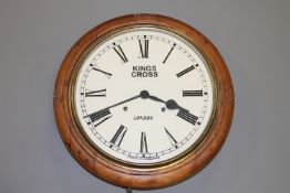 A Victorian and later mahogany wall clock, the dial later painted 'Kings Cross London'.