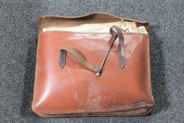 A vintage leather satchel containing sheet music