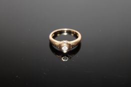 An 18ct gold ring set with a .15 solitaire diamond, 4.