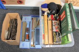 A box containing Hornby track and part train set together with a crate of board games, Subbuteo set,