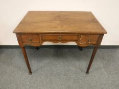 A George III oak side table fitted with three drawers, with 91 cm.