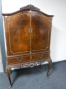 A Queen Anne style burr walnut cocktail cabinet