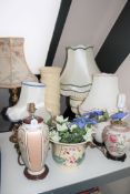 A pottery jardiniere on stand together with a brass table lamp and shade and five other table lamps