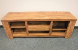 A contemporary hardwood entertainment stand, width 143 cm.