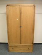 A Barker & Stonehouse light oak wardrobe fitted with a drawer,