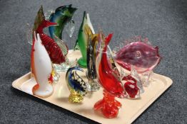 A tray containing ten coloured glass fish ornaments