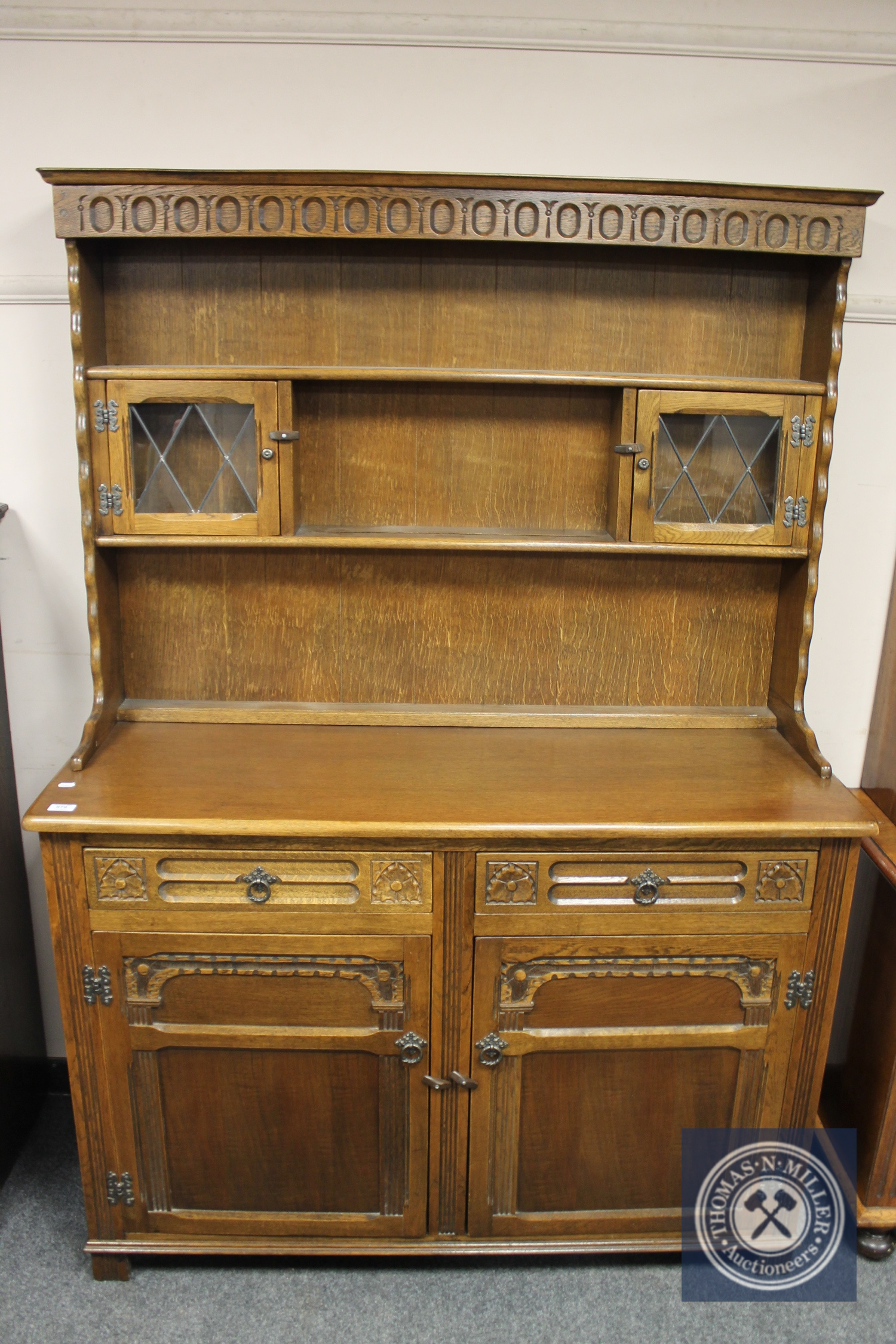 A reproduction carved oak dresser,