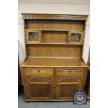 A reproduction carved oak dresser,