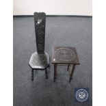 A carved ebonised occasional table together with a spinning chair
