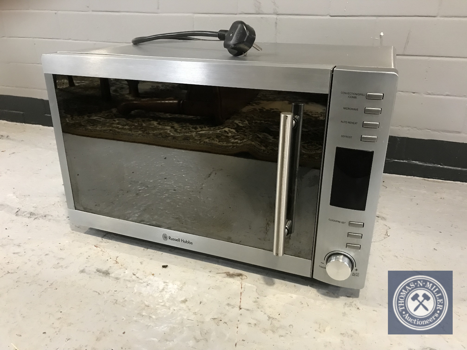 A stainless steel Russell Hobbs microwave with grill