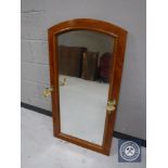 A mahogany wall mirror with brass sconces
