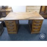 An early 20th century oak twin pedestal desk