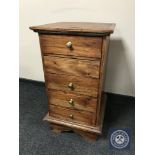 A contemporary narrow hardwood five drawer chest