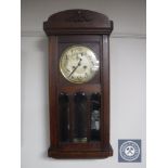 An early twentieth century oak wall clock