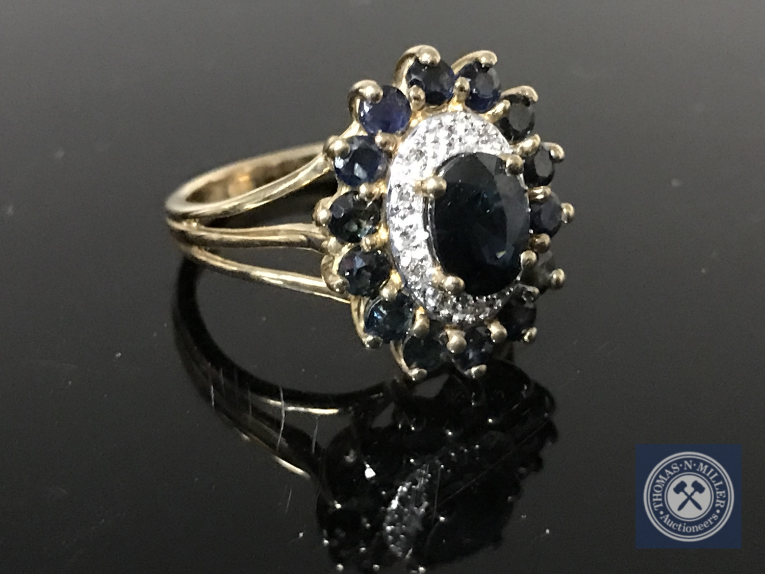 A 9ct gold sapphire and diamond cluster ring,