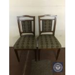 A pair of antique mahogany dining chairs