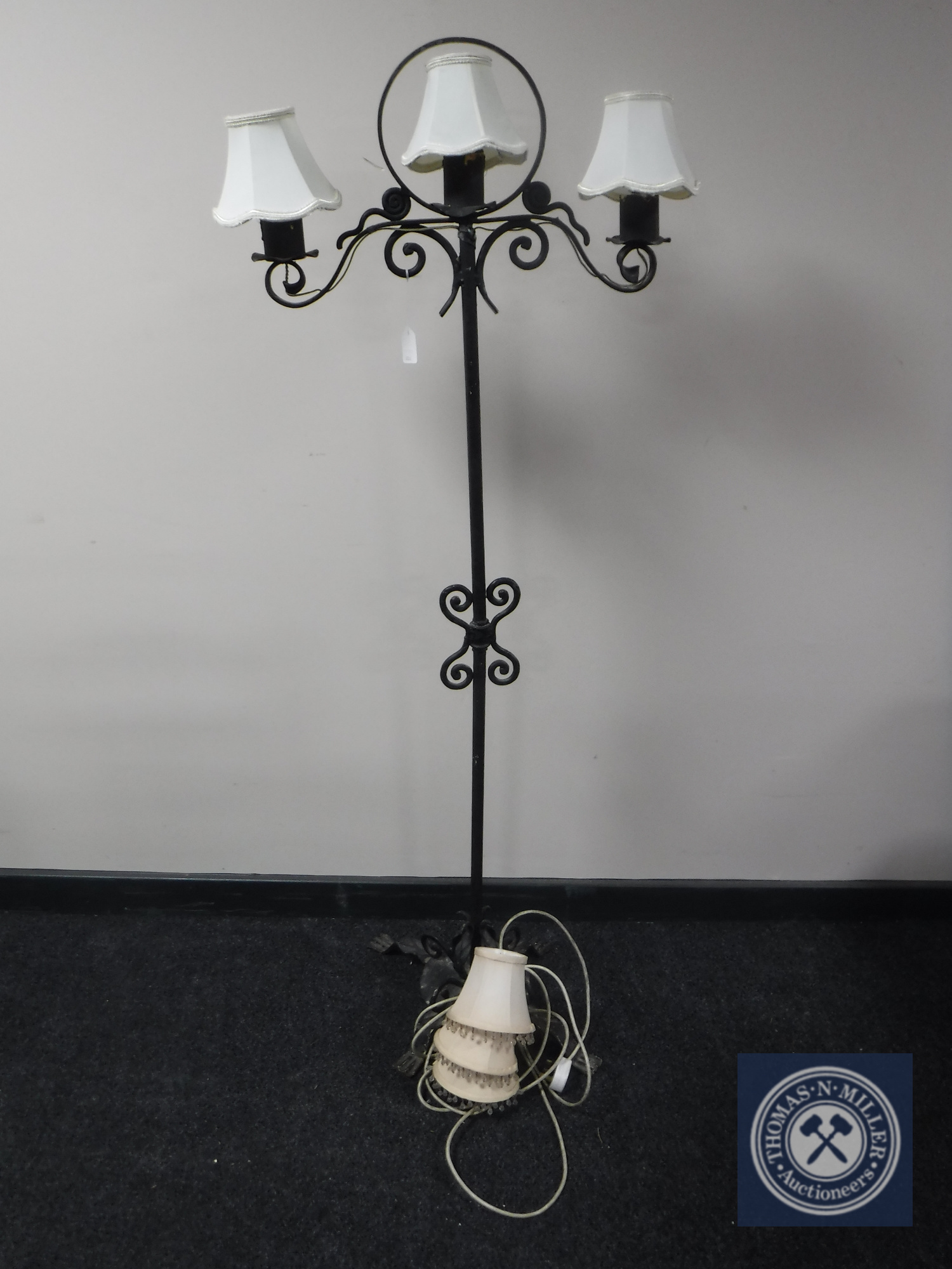 A cast metal three branch standard lamp