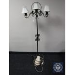 A cast metal three branch standard lamp