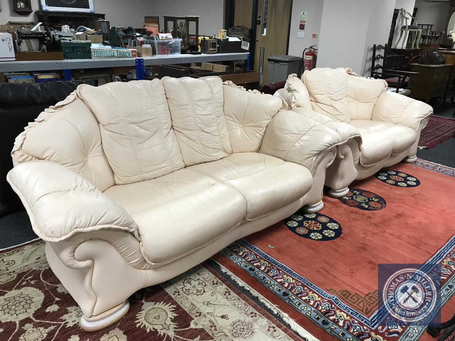 A three and two seater cream leather settee (2)