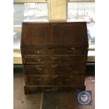 An inlaid mahogany Regency style bureau