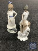 Three Nao figures of two girls and a basset hound