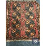 A fringed Afghan Bokhara rug,
