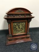 A mahogany arch top bracket clock with brass dial