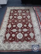 A Ziegler design rug on red ground,