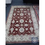 A Ziegler design rug on red ground,