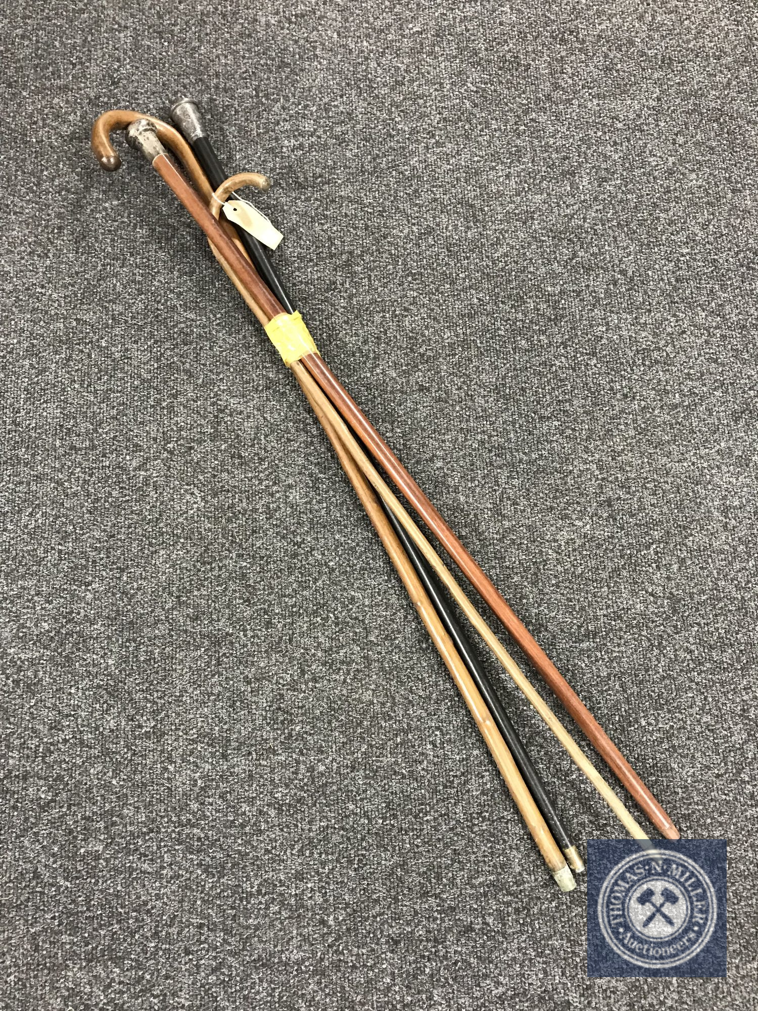 Two walking sticks together with two walking canes with silver mounts