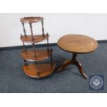 An oval mahogany pedestal occasional table together with a mahogany D-shaped four tier what-not