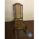 An antique mahogany bergere rocking chair